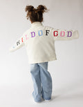 Cream Child of God fleece kids pullover with oversized fit and embroidered details for warmth and comfort