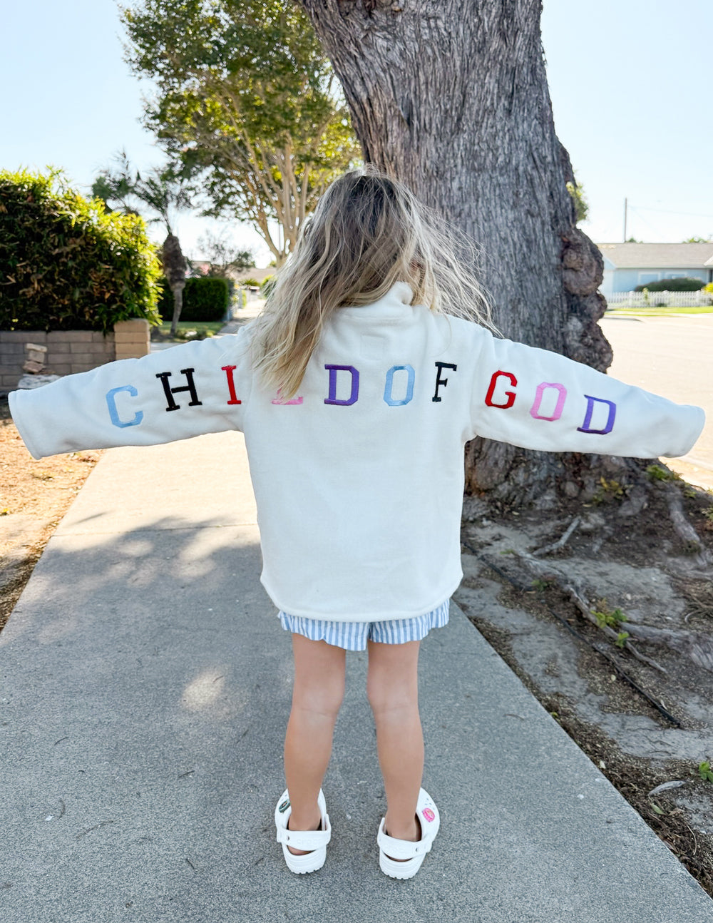 Cream oversized Child of God fleece kids pullover with embroidered logo and soft polyester material