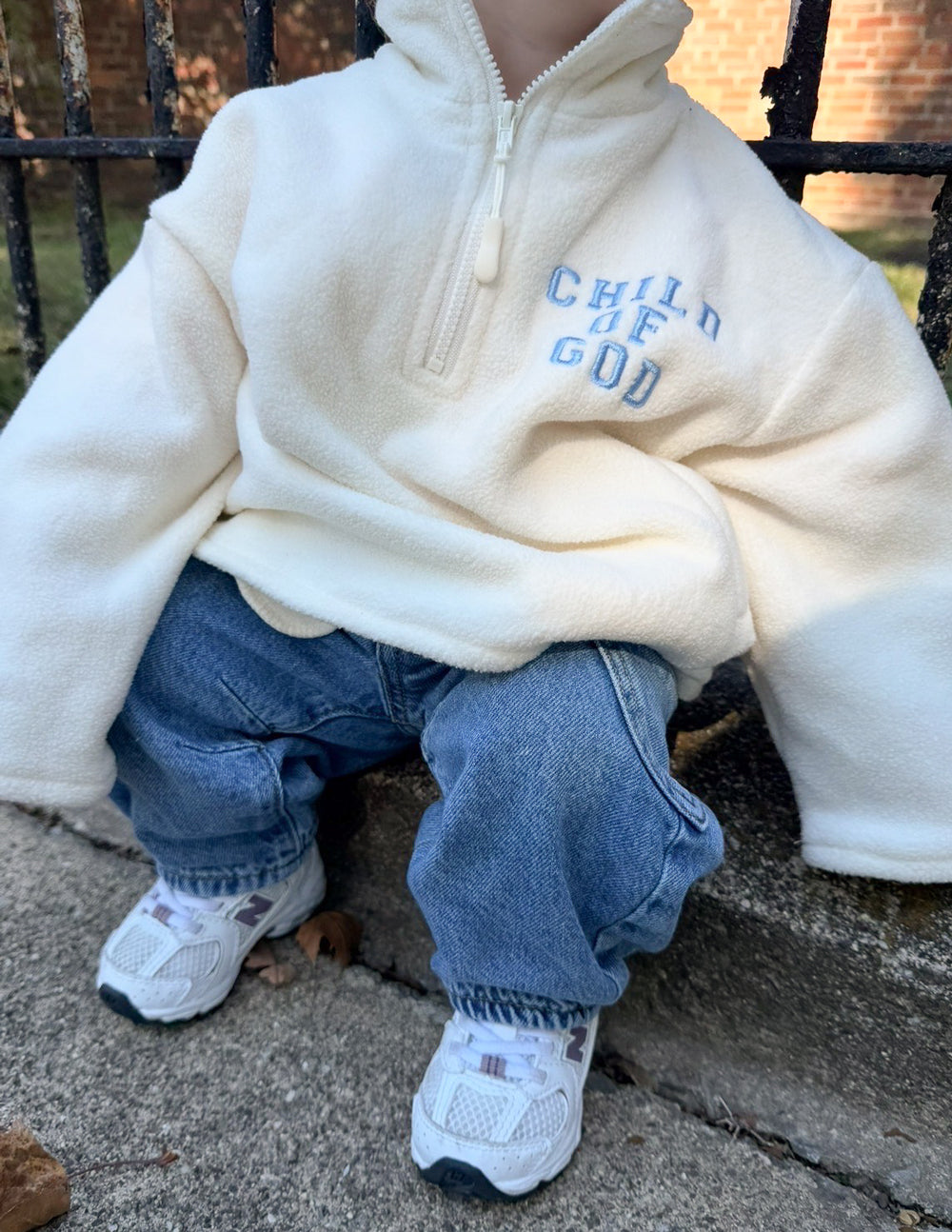 Cream Child of God fleece kids pullover with oversized fit and embroidered logo
