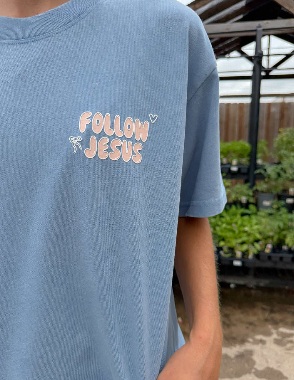Bluebell Follow Jesus Unisex Tee with puff print and oversized fit worn by model 5'4"