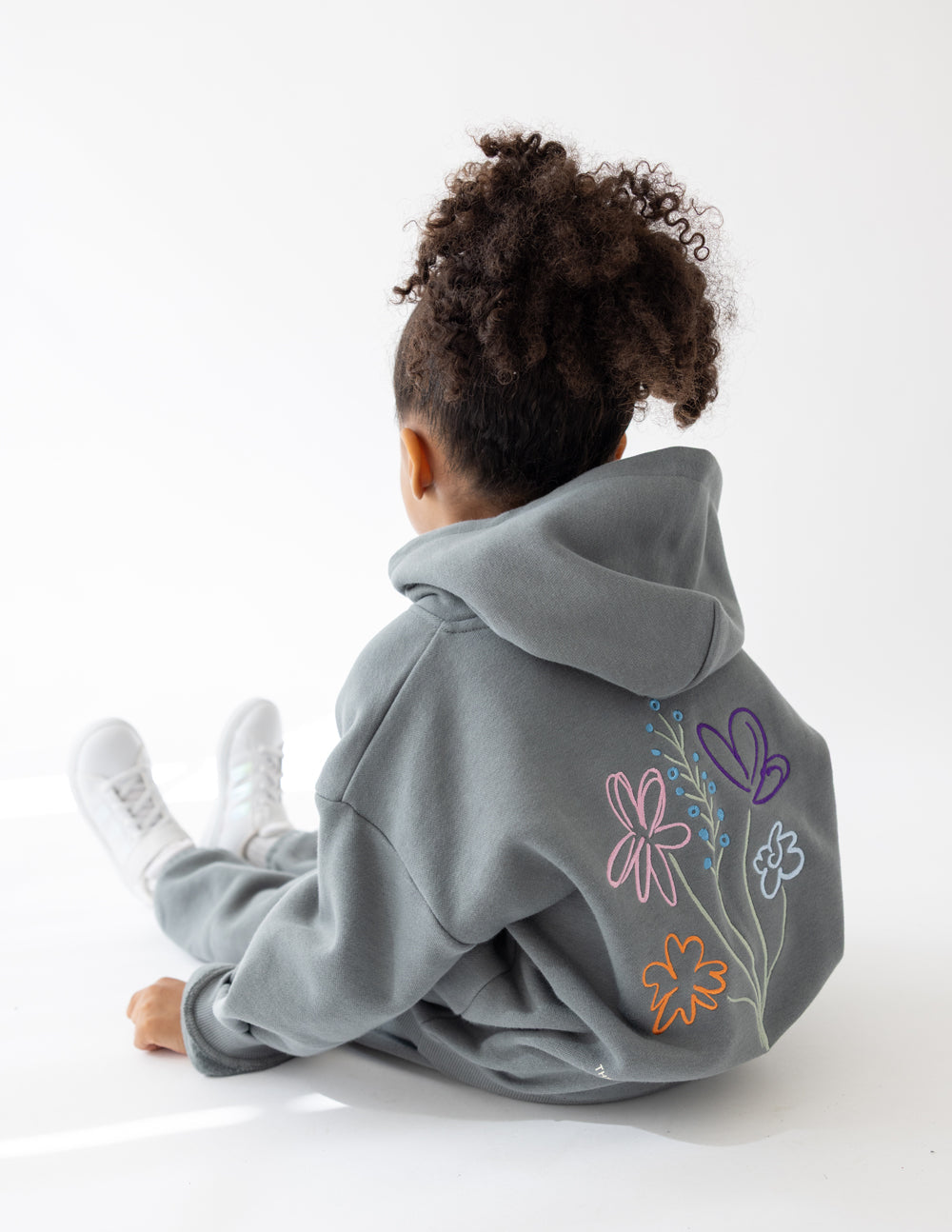 Kids wearing God's Still Working oversized Sedona Sage hoodie with Psalm 138:8 embroidery
