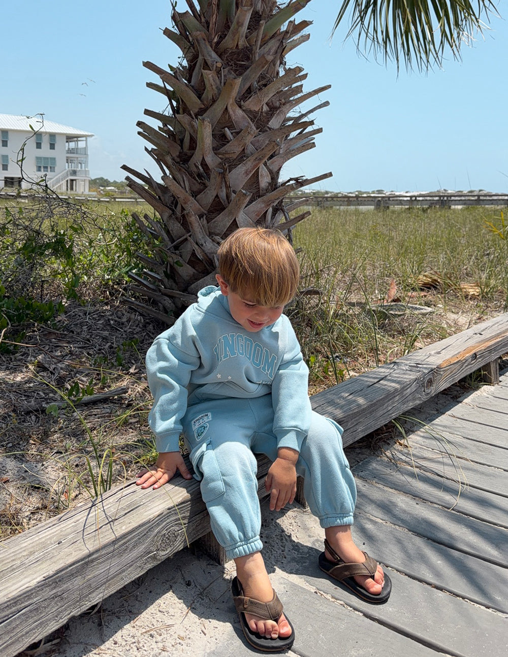 Child wearing Kingdom Kids Hoodie in air blue oversized fit with puff print, soft fabric and Luke 18:16 Bible verse.