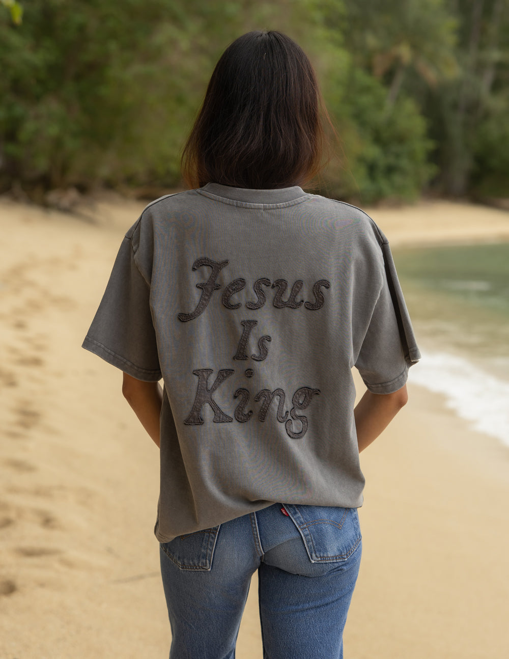 Not Sorry Jesus Is King heavyweight cotton tee with embroidered strikethrough and oversized appliqué lettering in spire grey color