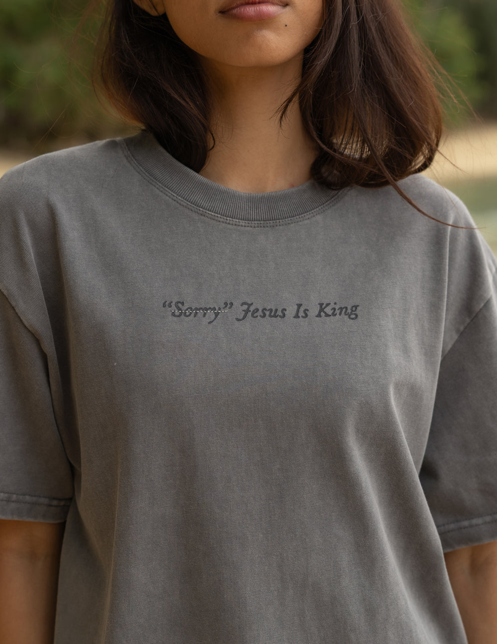 Not Sorry Jesus Is King heavyweight tee in spire grey with embroidered strikethrough and oversized tonal lettering, premium heavyweight cotton, modern relaxed fit.