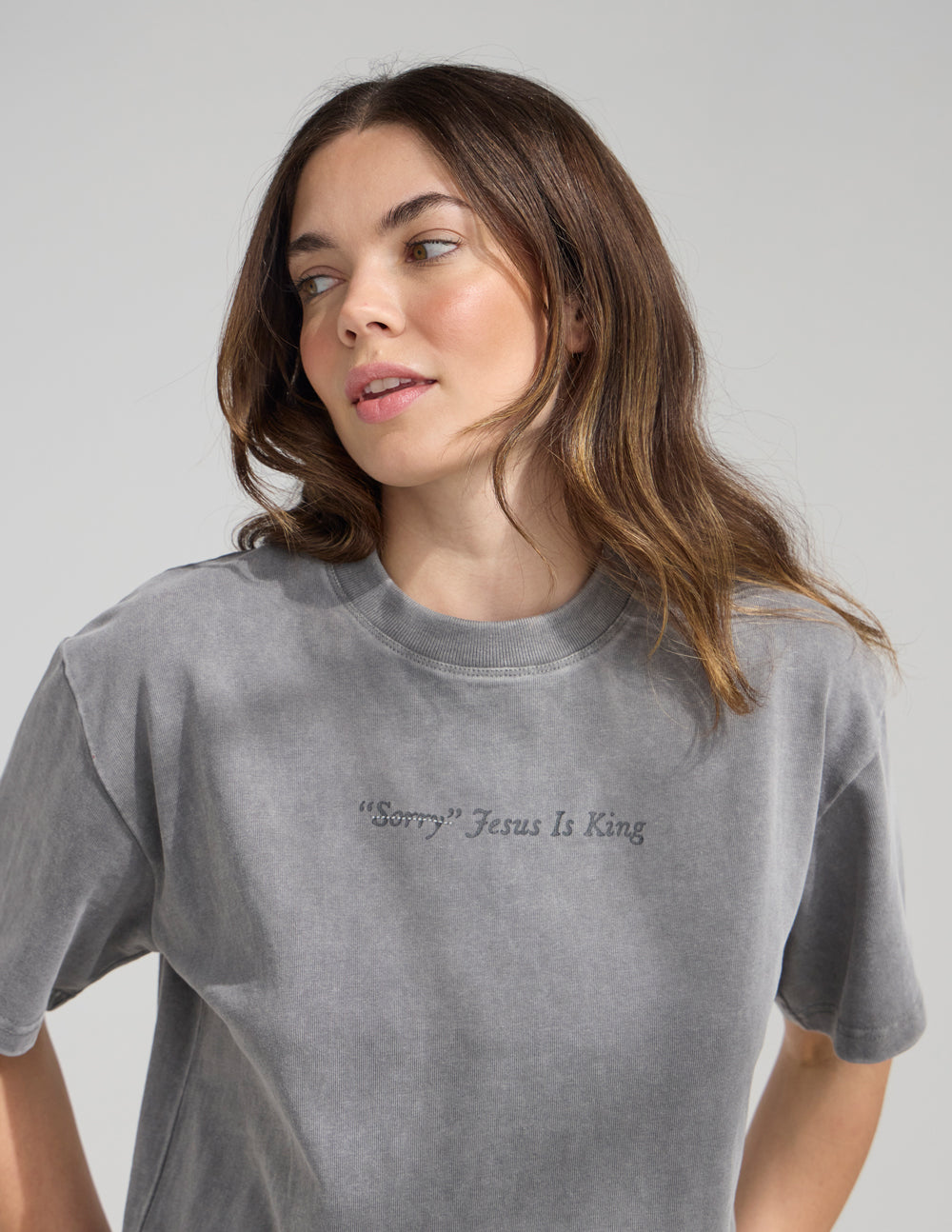 Not Sorry Jesus Is King heavyweight cotton tee with embroidered strikethrough and oversized back lettering in spire grey color