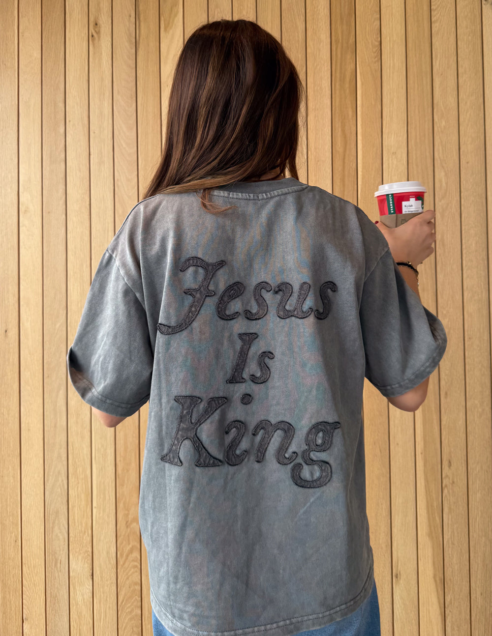 Not Sorry Jesus Is King heavyweight tee in spire grey with embroidered strikethrough and oversized applique lettering, made from 100% cotton, modern relaxed fit.