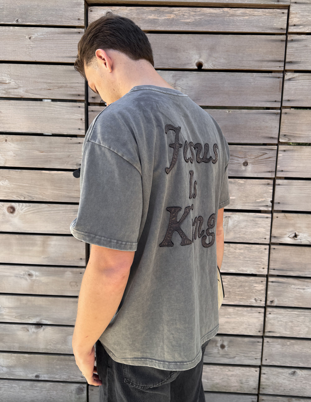 Not Sorry Jesus Is King heavyweight tee in spire grey with embroidered strikethrough and oversized appliqué lettering, made from 320 GSM cotton
