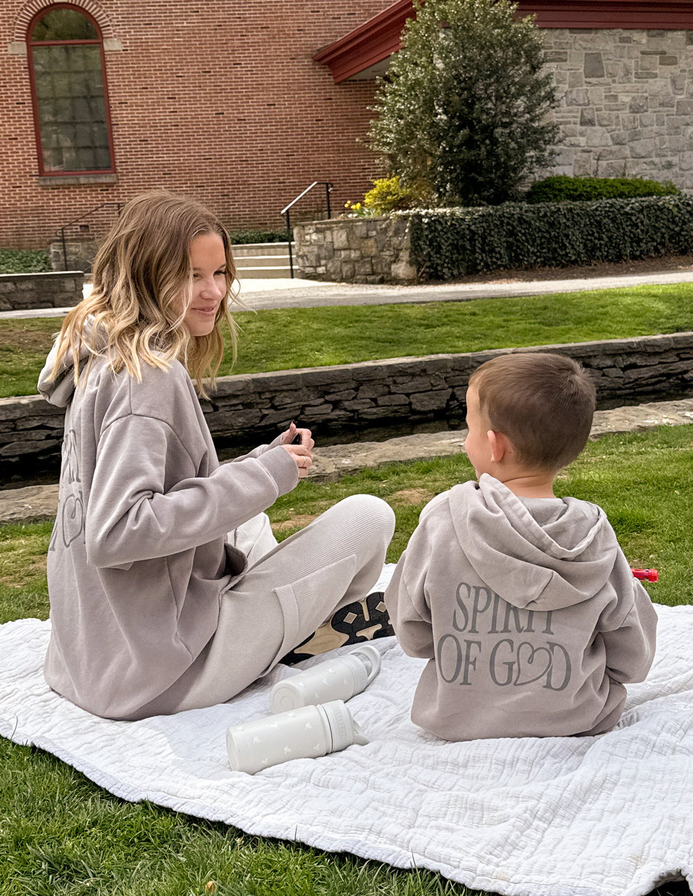 Child wearing oversized Spirit of God kids hoodie in echo color with scripture design