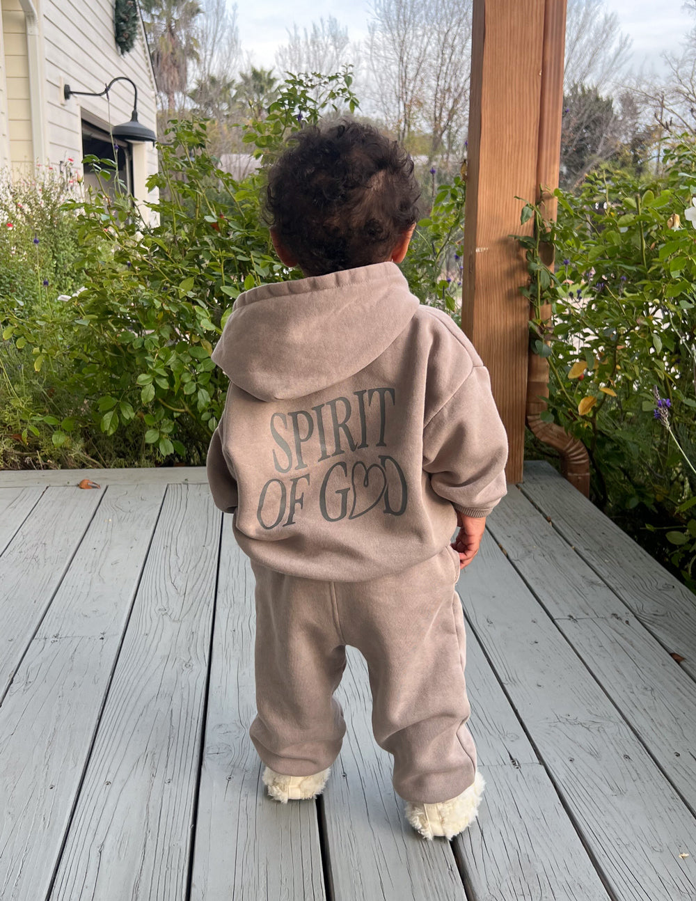 Child wearing oversized Spirit of God Kids Hoodie in echo color, soft and durable fabric with scripture design