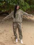 The Sacrifice Camo Hoodie unisex forest camo garment-dyed hoodie with 1 Corinthians 15:55 scripture print