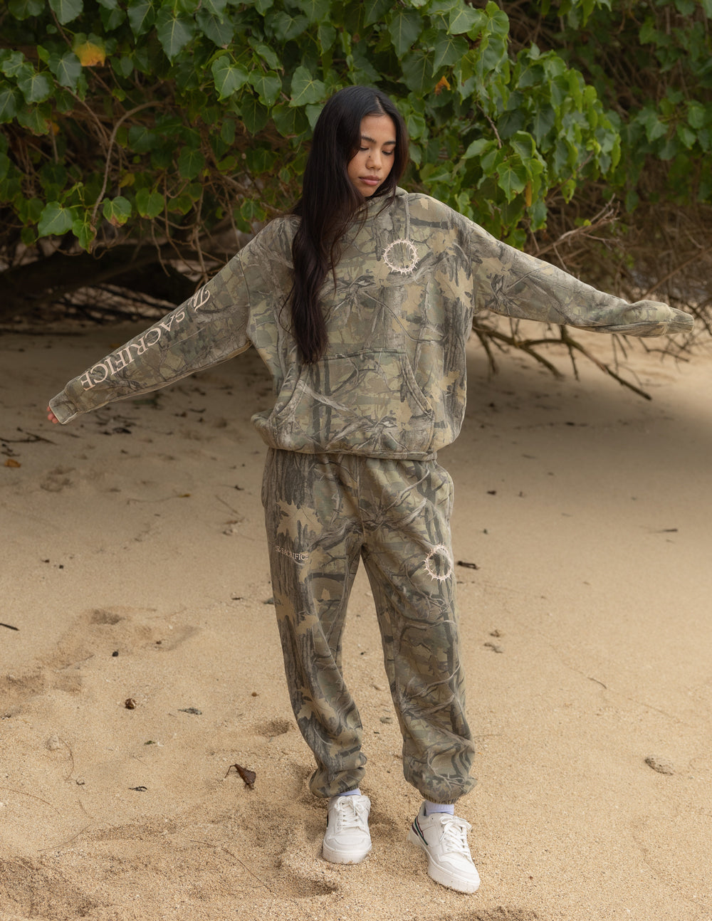 The Sacrifice Camo Hoodie unisex forest camo garment-dyed hoodie with 1 Corinthians 15:55 scripture print