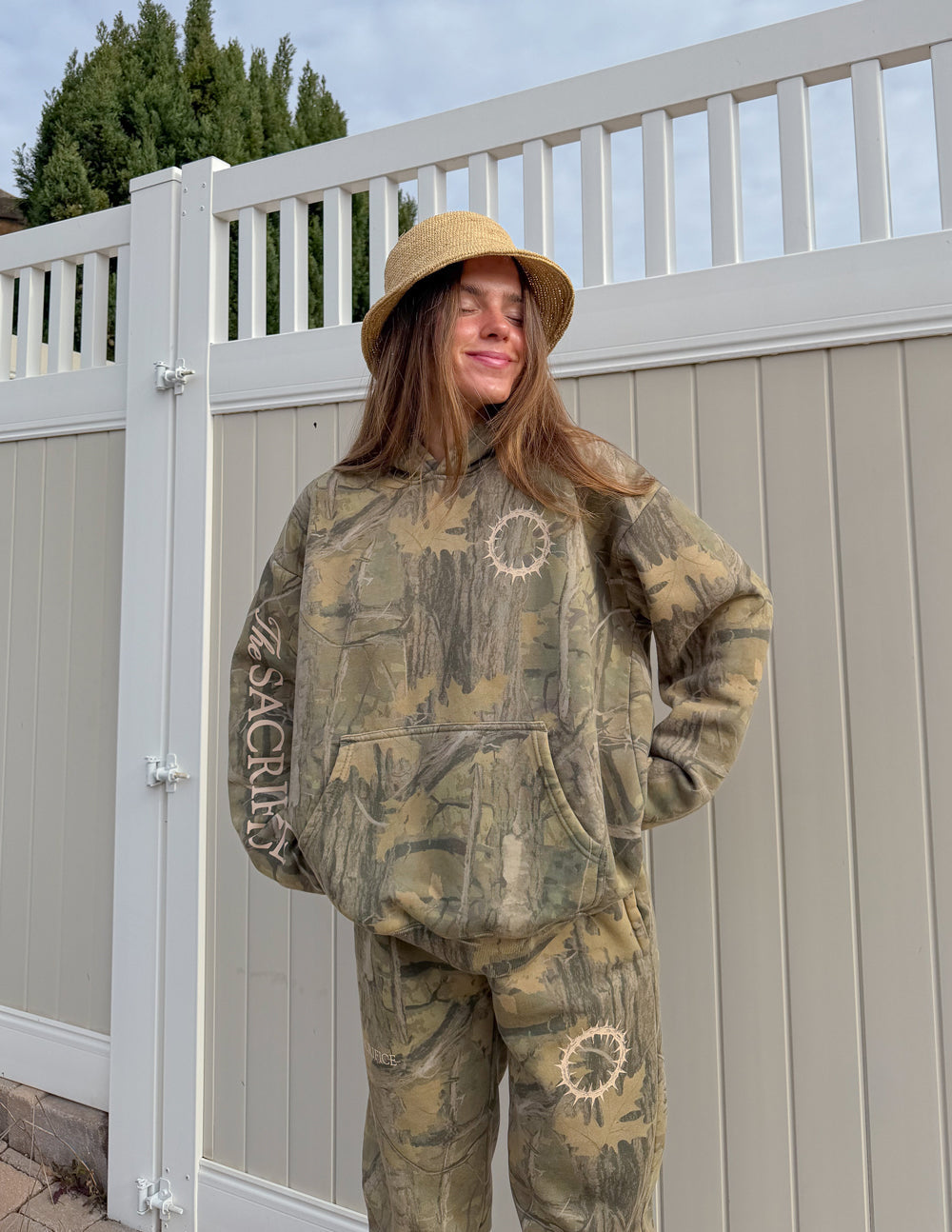 Unisex forest camo hoodie with 1 Corinthians 15:55 scripture print, relaxed fit and garment-dyed texture