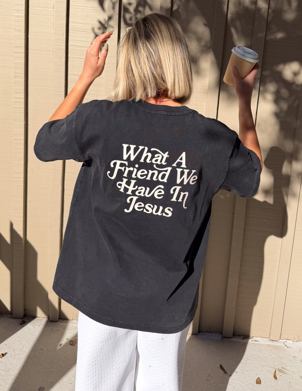 Black heavyweight cotton t-shirt with "What a Friend in Jesus" text and John 15:15 Bible verse in modern relaxed fit